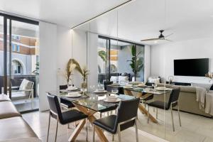 a dining room with a table and chairs at Elegance on Pine - by Coast Hosting in Terrigal