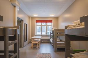 a room with bunk beds and a table and a window at Hyvärilä Youth- and Holiday Centre in Nurmes +76 photos