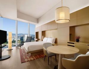 um quarto de hotel com uma cama e uma mesa em Park Hyatt Seoul em Seul