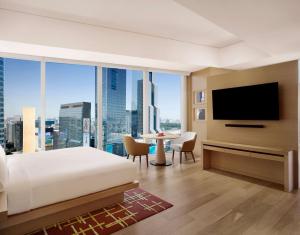 a hotel room with a bed and a television at Park Hyatt Seoul in Seoul