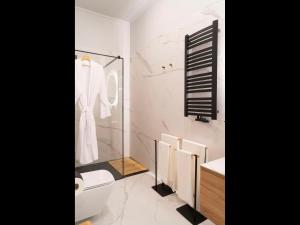 a bathroom with a shower and a toilet and a sink at MARIENSZTAT 8 Apartments in Warsaw