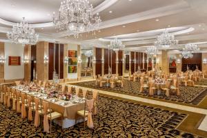 a large banquet hall with tables and chandeliers at Shangri-La Eros New Delhi in New Delhi