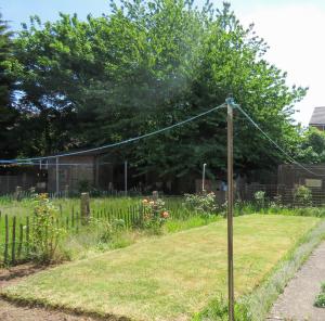 a garden with a telephone pole in the grass at Tudors eSuites 4 Bedroom House 9 Bed with Garden in Parkside