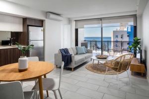 a living room with a couch and a table at First Light Mooloolaba, Ascend Hotel Collection in Mooloolaba