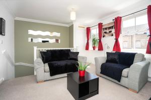 uma sala de estar com duas cadeiras e um sofá em Garland Rd Colchester em Colchester
