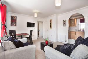 a living room with two couches and a table at Garland Rd Colchester in Colchester