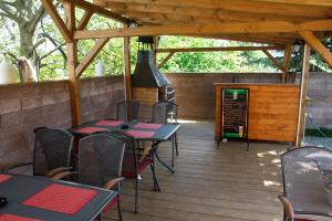 a patio with tables and chairs on a wooden deck at Restaurace-Penzion U Pilota in Kněževes +12 photos