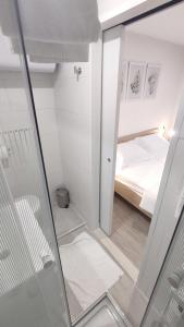 a small room with a bed and a mirror at 2023 Bruno - wifi and parking available in Portorož