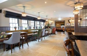 a restaurant with tables and chairs and a bar at The Craster Arms Hotel in Beadnell in Beadnell