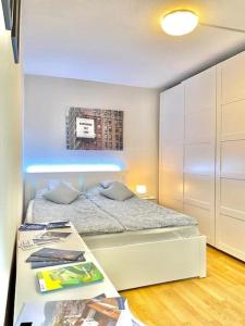 a small bedroom with a bed and a table at Suite 505 nel cuore di Zurigo in Zurich