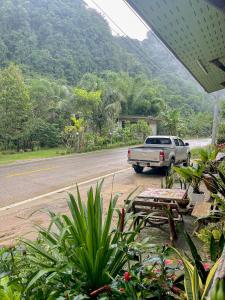 a truck parked on the side of a road at Khao Sok Green Mountain View in Khao Sok National Park