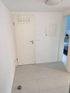 a room with a white door and a tile floor at Ferien- Monteurwohnung Sting Siegen in Siegen