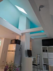 a room with a refrigerator and a blue ceiling at Ferien- Monteurwohnung Sting Siegen in Siegen