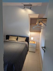 a bedroom with a bed and a lamp on a table at Ferien- Monteurwohnung Sting Siegen in Siegen