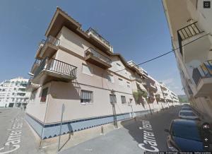a white building with balconies on the side of a street at Saras in Les Cases d'Alcanar