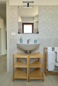 a bathroom with a sink and a mirror at La dimora del Cardinale in LʼAquila