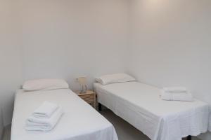 A bed or beds in a room at Primera Línea de Playa - MÁLAGA