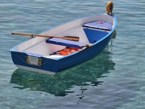 a blue and white boat sitting in the water at Eremo sul Mare in Marina di Fuscaldo