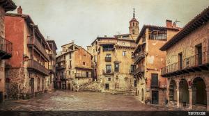 an old street in a town with a tower at El Rincón de Bezas in Bezas