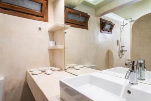 a bathroom with a sink and a shower at Agrilionas Hotel in Marathokampos