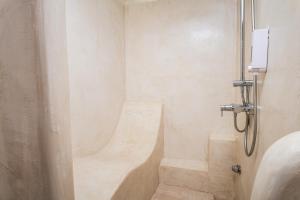 a bathroom with a shower with a tub at Agrilionas Hotel in Marathokampos