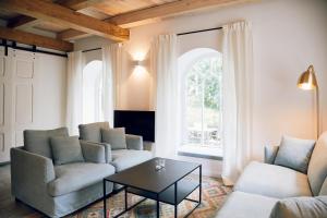 a living room with two couches and a table at Schmiede in Barkelsby