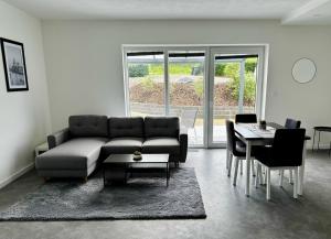 a living room with a couch and a table at Apartmány DEER House in Hodkovice nad Mohelkou