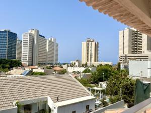 een uitzicht op de skyline van de stad met hoge gebouwen bij Neve Tsedek Rooftop in Tel Aviv