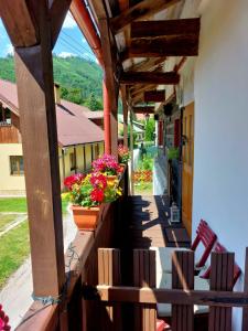 a balcony of a house with flowers on it at Chalupa pri Čerešni “Moja srdcovka” in Staré Hory