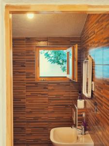 a bathroom with a sink and a window at Guest house Nizama's Place in Sarajevo