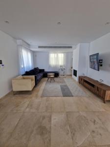 a living room with a couch and a table at Luxury 6 bedrooms villa in Cyprus in Paphos