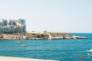 a view of a body of water with boats in it at A luxury apartment in Malta’s capital Valletta in Valletta