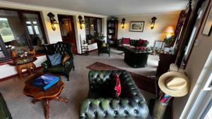 an aerial view of a living room with leather furniture at Springburn Farmhouse in Spean Bridge