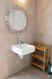 La salle de bains est pourvue d'un lavabo blanc et d'un miroir. dans l'établissement A luxury apartment in Malta’s capital Valletta, à La Valette