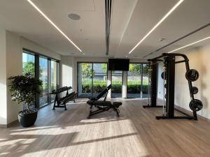 a gym with two treadmills and a flat screen tv at Luxurious one-bedroom very close to Dubai Mall in Dubai