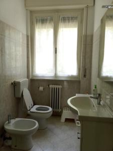 a bathroom with a toilet and a sink at Casa Felci in Tirrenia