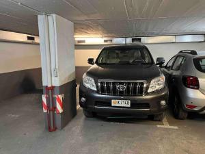 a parking garage with two cars parked in it at Centro Historico in Andorra la Vella