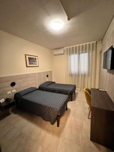 Postel nebo postele na pokoji v ubytování Hotel Colonna