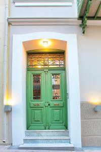 a green door on the side of a building at Atsiki's 54 apartments in Chios