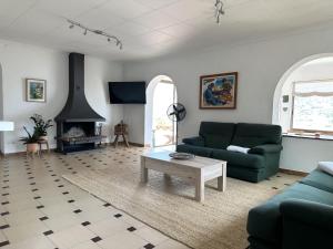 een woonkamer met een bank en een open haard bij LETS HOLIDAYS Beautiful house sea views in Tossa de Mar