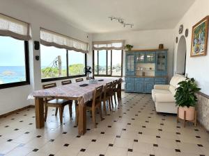 a dining room with a table and chairs and the ocean at LETS HOLIDAYS Beautiful house sea views in Tossa de Mar