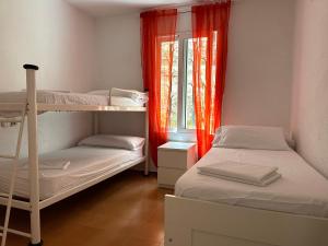 a room with two bunk beds and a window at LETS HOLIDAYS Beautiful house sea views in Tossa de Mar