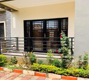 a house with a balcony with a black door at Appartement meublé grand luxe à Essos in Yaoundé