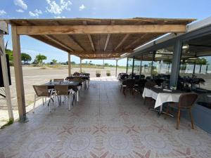 a restaurant with tables and chairs on a patio at Hotel Restaurant La Ceinture in Montcalm