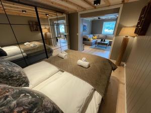 a bedroom with a bed and a living room at Lofoten Planet Studio in Sørvågen