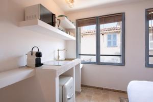 a kitchen with a sink and a window at Pick A Flat's Apartments in Saint-Tropez - Rue des Bouchonniers in Saint-Tropez
