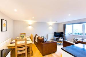 a kitchen and living room with a table and a dining room at Applegarth in Buxton