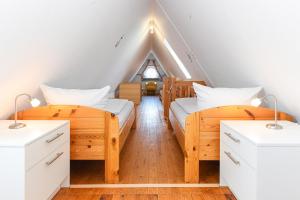 two beds in a room with a roof at Ferienwohnung Inselblick in Bensersiel