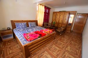 a bedroom with a bed and a wooden floor at Spiti Homestay by StayApart in Spiti