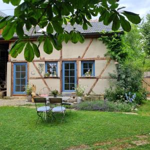 a table and chairs in front of a house at Ankommen, Wohlfühlen und die Natur genießen in Lichtenhain